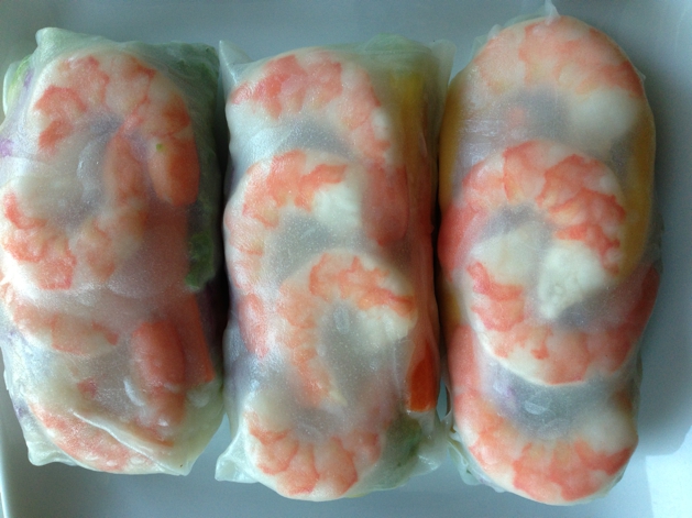 Once your spring roll skins are fully wrapped, the shrimp should show through the top.