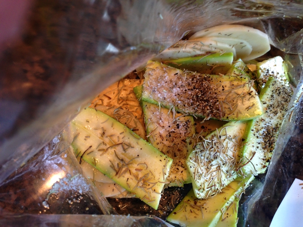 Evenly sliced veggies with olive oil, sea salt, black pepper, and parmesan in a ziploc baggie. 