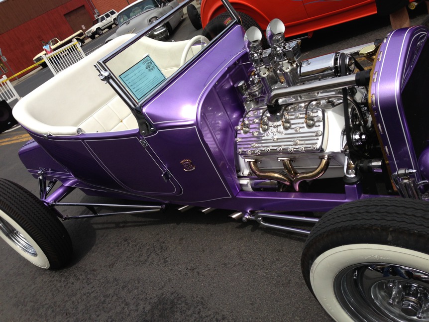 This vintage car looks great in its coat of shiny purple with the white upholstery.