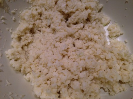 Crumbled cauliflower bits are ready for the first step in forming the flour-less pizza dough.